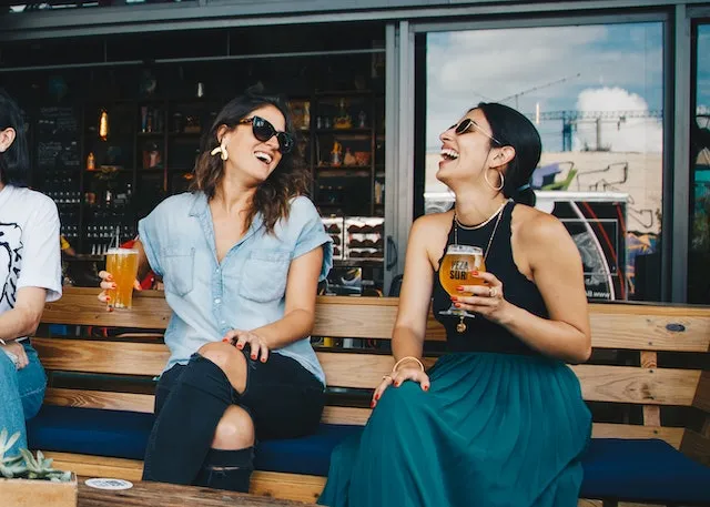 Aquarius friends enjoying lively conversation and laughter, reflecting the zodiac sign's sociable nature, open-mindedness, and appreciation for meaningful friendships.