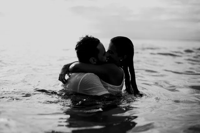 Couple embracing in the ocean, symbolizing Cancer's deep emotional bonds, romantic devotion, and intuitive approach to love and relationship compatibility.