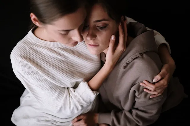 Two close friends sharing a comforting embrace, symbolizing Cancer's loyalty, compassion, emotional support, and deep connections in friendship and relationships.