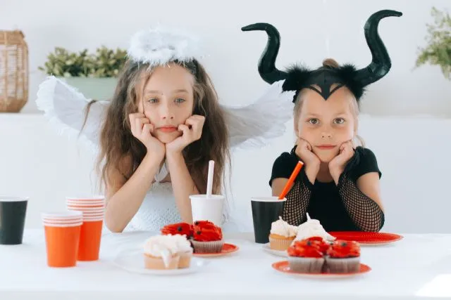 Two children dressed as angel and devil, illustrating Gemini's dual nature, adaptability, and contrasting personality traits.