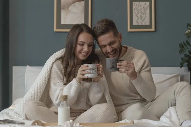 Leo and Aquarius sharing a warm moment together, representing the balance between Leo's passion and Aquarius's independence in a complementary relationship.