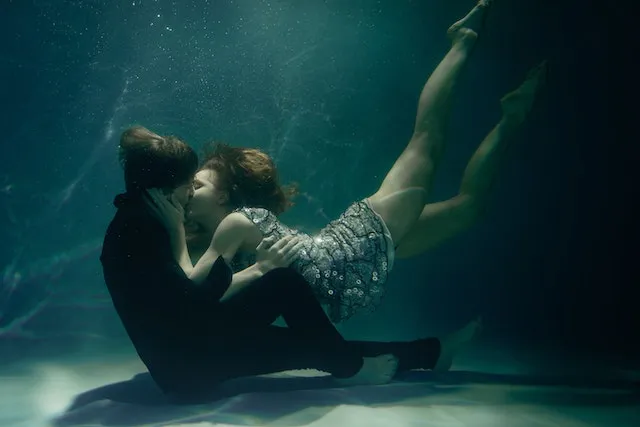Pisces and Virgo couple embracing underwater, symbolizing emotional depth, trust, unconditional love, and the balance between intuition and practicality.