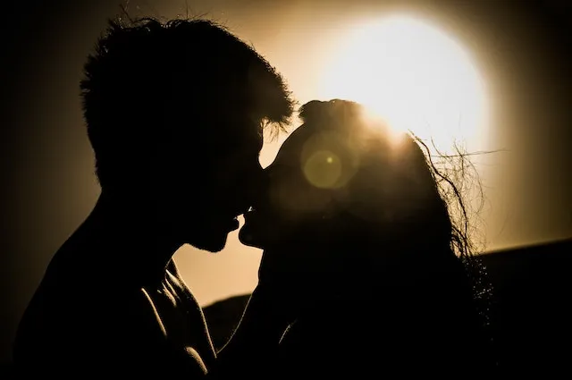 Romantic couple sharing an intimate sunset moment, symbolizing the adventurous, playful, and communicative compatibility between Sagittarius and Gemini.