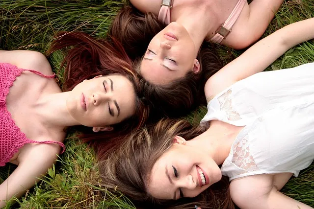 Three close friends relaxing together outdoors, representing Virgo's loyal friendships, trust, and dependable social connections.