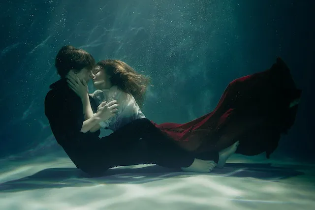 Virgo and Pisces sharing a peaceful underwater embrace, representing the balance between Virgo's practicality and Pisces' emotional depth.